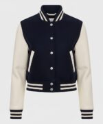 Varsity bomber jacket with navy body, cream sleeves, and striped ribbed cuffs and collar for stylish athletic wear.